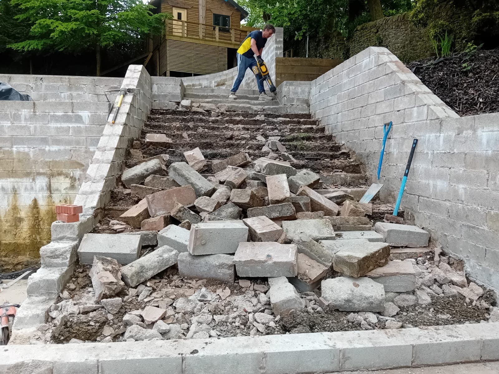 Tony on the breaker, mid-demolition of old steps on a Rossendale Valley job